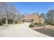 Brick home with a driveway leading to a garage and a small deck at 4805 Mystere Sw Ln, Lilburn, GA 30047