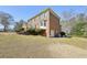 Side view of a brick home showing a garage and landscaped garden at 4805 Mystere Sw Ln, Lilburn, GA 30047