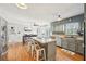 Bright and airy kitchen featuring a large island, stainless steel appliances, and hardwood floors at 4805 Mystere Sw Ln, Lilburn, GA 30047