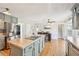 Well-equipped kitchen with stainless steel appliances, a center island, and stylish light fixtures at 4805 Mystere Sw Ln, Lilburn, GA 30047