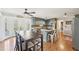 Kitchen and dining space with hardwood floors, modern cabinets, stainless appliances, and french doors to deck at 4805 Mystere Sw Ln, Lilburn, GA 30047