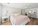 Comfortable main bedroom with a ceiling fan, wood floors, and ensuite bath with a large soaking tub at 4805 Mystere Sw Ln, Lilburn, GA 30047