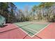 Well maintained tennis court surrounded by mature trees at 4805 Mystere Sw Ln, Lilburn, GA 30047