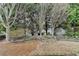 Backyard with mulched ground cover and mature trees offers privacy and serenity at 1635 Vinery Ave, Cumming, GA 30041