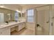 A bright, dual sink bathroom features a glass enclosed shower and tile flooring for a clean and modern aesthetic at 1635 Vinery Ave, Cumming, GA 30041