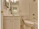 Bright bathroom with vanity sink, toilet, and shower-tub with tile surround at 1635 Vinery Ave, Cumming, GA 30041