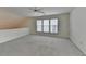 Loft-style bedroom with neutral carpet and a ceiling fan for added comfort and climate control at 1635 Vinery Ave, Cumming, GA 30041