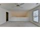 Upstairs loft area with neutral carpet and staircase view at 1635 Vinery Ave, Cumming, GA 30041