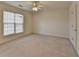 Large bedroom with natural light, neutral carpet, and a closet for storage at 1635 Vinery Ave, Cumming, GA 30041