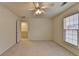 Spacious bedroom features neutral carpeting, a ceiling fan and a window with blinds at 1635 Vinery Ave, Cumming, GA 30041