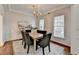 Elegant dining room featuring hardwood floors, a chandelier, and ample natural light at 1635 Vinery Ave, Cumming, GA 30041