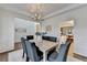 Elegant dining room featuring hardwood floors, a chandelier, and ample natural light at 1635 Vinery Ave, Cumming, GA 30041