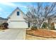 Charming home featuring a two-car garage and inviting curb appeal with a manicured lawn at 1635 Vinery Ave, Cumming, GA 30041