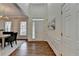 Bright and airy foyer with hardwood floors and a chandelier, leading to dining and living areas at 1635 Vinery Ave, Cumming, GA 30041