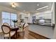 Eat-in kitchen features white cabinets, black countertops, stainless steel appliances and a wood table with four chairs at 1635 Vinery Ave, Cumming, GA 30041