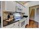 Well-equipped kitchen with modern appliances, granite countertops, and hardwood floors at 1635 Vinery Ave, Cumming, GA 30041