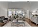 Open concept living room with hardwood floors, fireplace, and view of the eat-in kitchen at 1635 Vinery Ave, Cumming, GA 30041