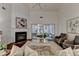 Spacious living room with vaulted ceilings, fireplace and sliding glass doors to sunroom at 1635 Vinery Ave, Cumming, GA 30041