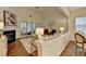 Bright living room with hardwood floors, fireplace and view into sunroom and dining room at 1635 Vinery Ave, Cumming, GA 30041