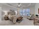 The main bedroom offers a ceiling fan, tray ceiling, carpet, and ample natural light, creating a spacious and serene retreat at 1635 Vinery Ave, Cumming, GA 30041