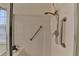 Close-up of a shower featuring a handheld shower head and grab bars for safety and convenience at 1635 Vinery Ave, Cumming, GA 30041