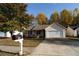 Inviting front exterior of home with a spacious driveway and neatly maintained lawn at 244 Amelia Garden Way, Lawrenceville, GA 30045