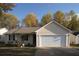 Charming single-story home with a well-manicured lawn and attached two car garage at 244 Amelia Garden Way, Lawrenceville, GA 30045