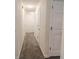 Hallway with carpet flooring and access to multiple rooms at 244 Amelia Garden Way, Lawrenceville, GA 30045