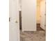 Hallway view leading to a bathroom featuring gray carpet flooring and a nearby bedroom at 244 Amelia Garden Way, Lawrenceville, GA 30045