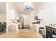 Cozy kitchen featuring stainless steel appliances, white cabinets, and a view into a spacious living area at 244 Amelia Garden Way, Lawrenceville, GA 30045