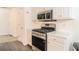 Bright kitchen with stainless steel range and microwave with white cabinets and countertops at 244 Amelia Garden Way, Lawrenceville, GA 30045