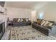 Inviting living room with sofas, decorative rug, and a fireplace enhancing the home's ambiance at 244 Amelia Garden Way, Lawrenceville, GA 30045