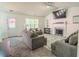 Cozy living room featuring two gray sofas, a fireplace, and a doorway to the outside at 244 Amelia Garden Way, Lawrenceville, GA 30045