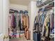 Organized walk-in closet with ample storage space for clothes, shoes, and accessories at 244 Amelia Garden Way, Lawrenceville, GA 30045