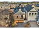 Aerial view of the property showcasing the well-maintained home with a two-car garage and landscaped front yard at 322 Gray Shingle Ln, Woodstock, GA 30189