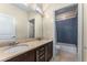 Bathroom featuring a double sink vanity, tile backsplash and access to a shower tub combo at 322 Gray Shingle Ln, Woodstock, GA 30189