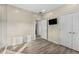 Bedroom with light wood floors, neutral paint and a wall mounted TV at 322 Gray Shingle Ln, Woodstock, GA 30189