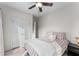 Well-lit bedroom with a ceiling fan, closet, and large windows providing natural light at 322 Gray Shingle Ln, Woodstock, GA 30189