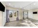 Bright bedroom with gray vinyl floors, large mirror and big windows with view of the home next door at 322 Gray Shingle Ln, Woodstock, GA 30189