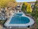 Aerial view of a large community pool covered with a tarp, surrounded by a fence and mature trees at 322 Gray Shingle Ln, Woodstock, GA 30189