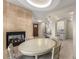 Bright dining room features a fireplace, entry door and a large dining table with seating for four at 322 Gray Shingle Ln, Woodstock, GA 30189