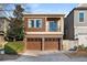 Two-story home boasts a two-car garage and a charming balcony overlooking a lush front yard at 322 Gray Shingle Ln, Woodstock, GA 30189