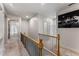 Well-lit hallway with railing and a large picture hanging on the wall at 322 Gray Shingle Ln, Woodstock, GA 30189