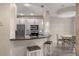 Open concept kitchen and dining area, featuring white cabinets, stainless steel appliances, and granite countertops at 322 Gray Shingle Ln, Woodstock, GA 30189