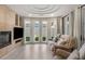 Bright living area with large windows, a cozy fireplace, and comfortable seating at 322 Gray Shingle Ln, Woodstock, GA 30189