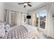 Bright bedroom with large windows, patio doors to the balcony, and a light color palette at 322 Gray Shingle Ln, Woodstock, GA 30189