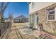 Backyard patio featuring outdoor seating, landscaping, a brick exterior, and natural sunlight at 3362 Brockenhurst Dr, Buford, GA 30519