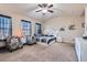 Inviting bedroom featuring a ceiling fan and comfortable seating area at 3362 Brockenhurst Dr, Buford, GA 30519