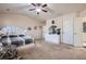 Spacious main bedroom featuring plush carpet, a ceiling fan, and ensuite bathroom at 3362 Brockenhurst Dr, Buford, GA 30519