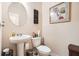 Charming powder room featuring a pedestal sink, toilet, and tasteful decor at 3362 Brockenhurst Dr, Buford, GA 30519